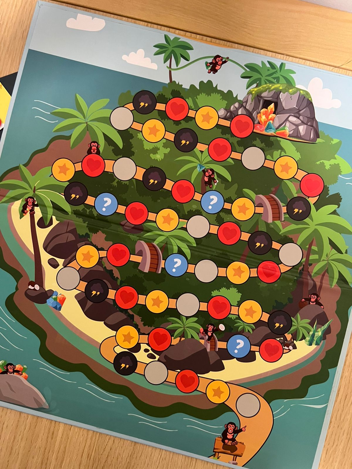 Board game map with colorful markers on a wooden surface
